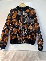 Front view of animal print bomber jacket on hanger