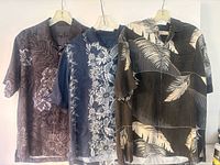 All three shirts hanging to show fronts and patterns