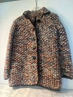 Front view of the coat showing button closure and overall texture