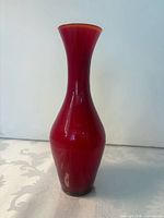 Full front view of cranberry glass bud vase