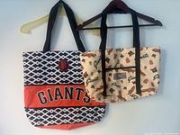 Front view of both tote bags showing designs and size difference