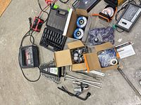 Overall lot showing charger, socket set, flap discs, PDR parts, rods and hand tools