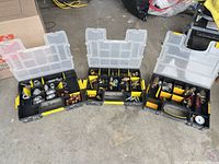 All three open organizer cases showing assorted fittings and pressure gauge