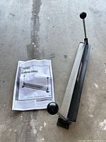 Bending brake with owner's manual on floor