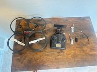 Drone, controller, batteries, charger on table