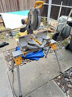 Front view of DeWALT DW716 miter saw positioned on folding stand