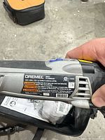 Close-up of Dremel MM35 label showing model, voltage and OPM range