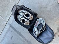 Open roller bag holding Dexter shoes and shoe covers