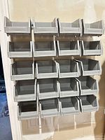 Front view of 20 gray bins mounted on rail