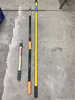 Three telescoping poles laid out showing relative lengths and colors