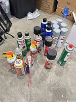 Group shot of all aerosol cans arranged on floor
