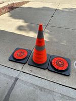 Three cones, two collapsed showing fold-flat bases