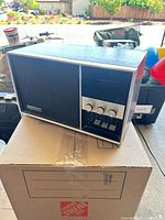 Front three-quarter view of Panasonic RE-7500 radio showing speaker grille and control panel