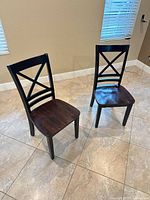 Front view of both wood X-back dining chairs