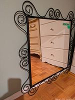 Full view of mirror front showing scrollwork frame