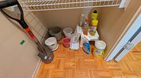 Group view of shovel, planters, cleaning items in closet