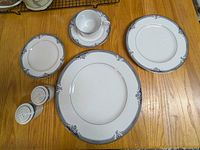 One full place setting with salt & pepper shakers