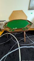 Full view of octagonal poker table with cover panel behind