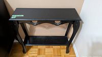 Black wood console table with lower shelf