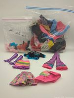 Overall lot with laid-out sample clothing and boots plus two zip bags of additional items