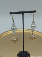 Both earrings on stand showing full design