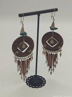 Full view of both earrings on stand