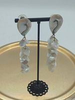 Full view of both earrings on stand