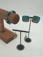 All three jewellery pieces on display stands