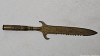 Overall view of brass trench art letter opener with engraved blade and cartridge handle