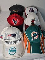 Front view of six sports team caps