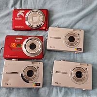 Front view of five Kodak EasyShare cameras showing colour, model markings and lens details