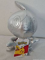 Front view of silver Sobble plush with tag visible