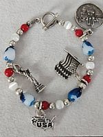 Full view of sterling bracelet showing beads, toggle clasp and five patriotic charms