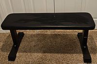 Full front view of black flat weight bench