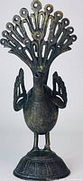 Front view of bronze peacock showing tail, body, and base