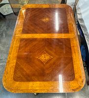 Top view of dining table showing marquetry pattern and condition