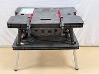 Front view of folded Keter workbench set on its legs showing overall condition