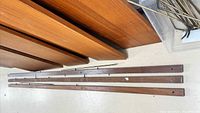 shelves stacked with three wood rails and support pins visible