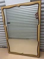 Full view of rectangular gold framed mirror