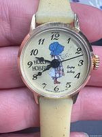 Front view showing Holly Hobbie dial, bezel, hands and strap