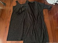 Dress and cardigan laid out together showing matching fabric