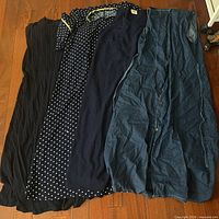 Four dresses laid side by side showing styles and colors