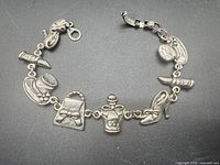 Full view of silver charm bracelet with assorted charms