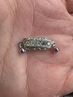 Front view showing five stones and engraved border