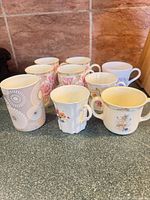 All nine assorted mugs on countertop