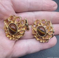 Pair of gold-tone Dior cufflinks front view