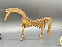Full view of brass Dhokra horse sculpture showing overall shape and patina