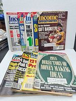 Group shot showing stack of nine Income Opportunities magazines with visible covers