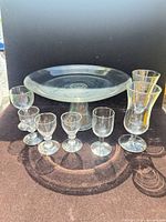 full set clear glass pedestal cake stand with five small stem glasses and two taller stem glasses