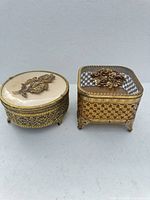 Both ormolu trinket boxes side by side showing size and style contrast